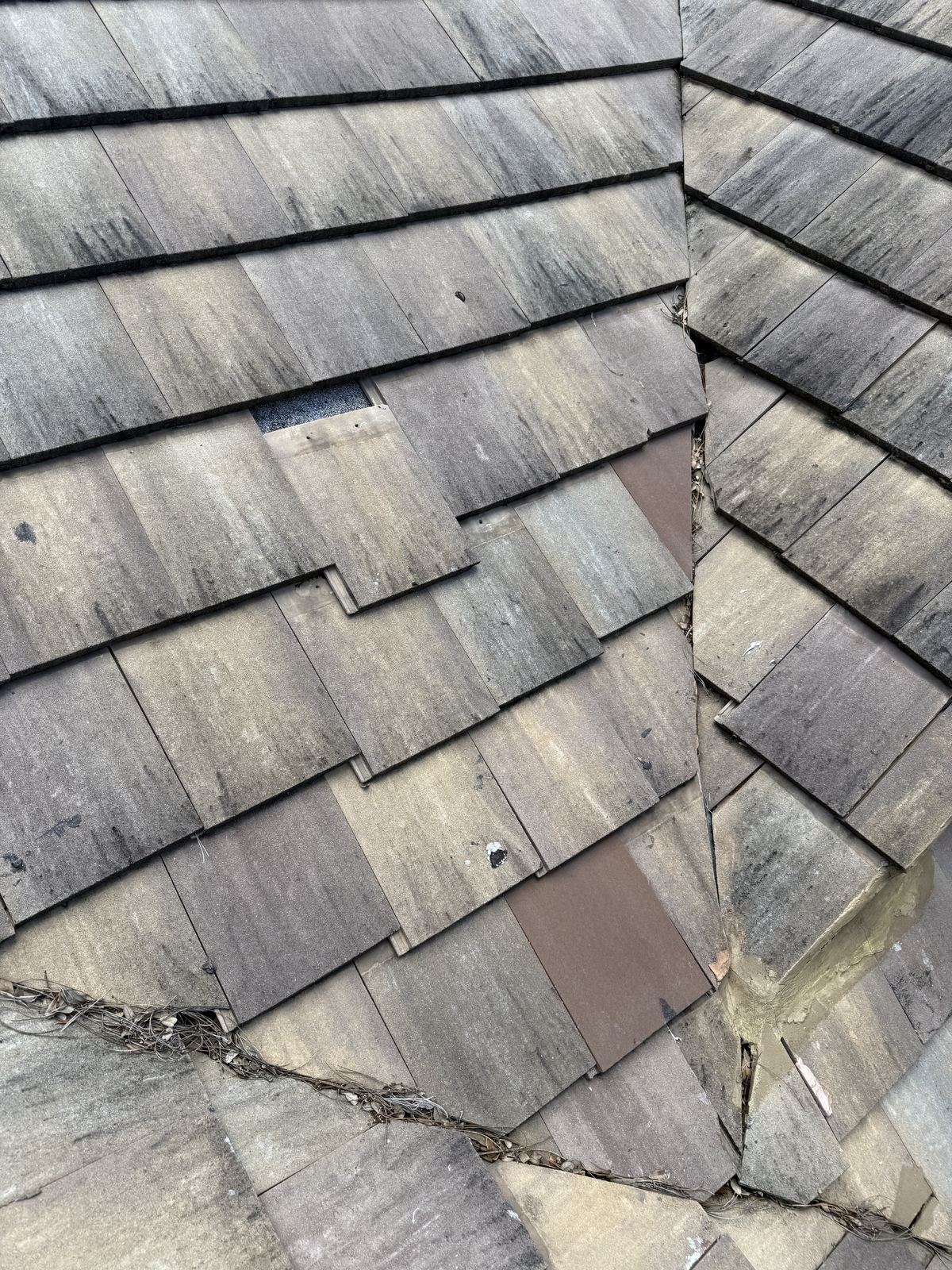 Loose, crooked tile with mastic over a valley